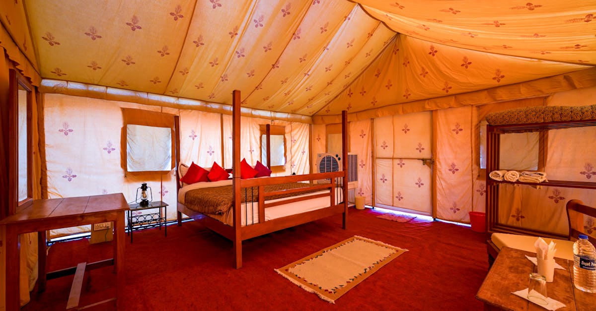 Explore the cozy interior of a desert camp tent in Jaisalmer, India, featuring elegant decor and comfort.